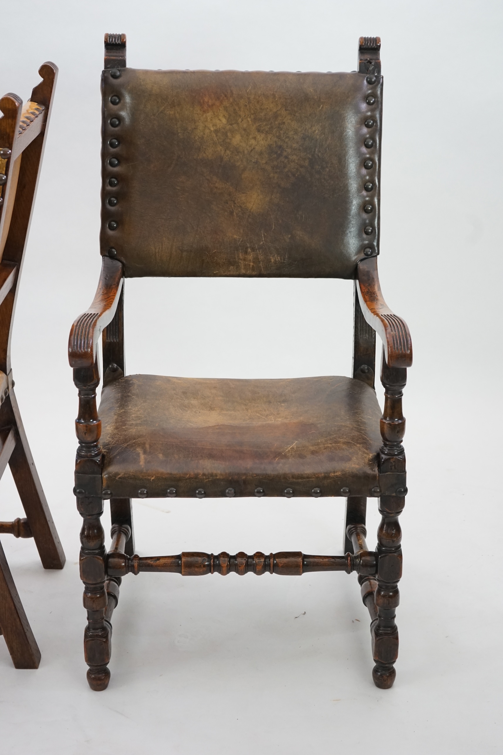 A set of fourteen 17th century style oak dining chairs including a pair of carvers